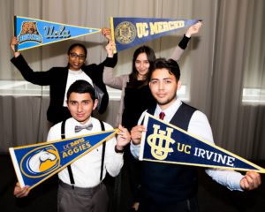 Four of Aspire's Shining Stars graduates holding their college pennants in their hands.